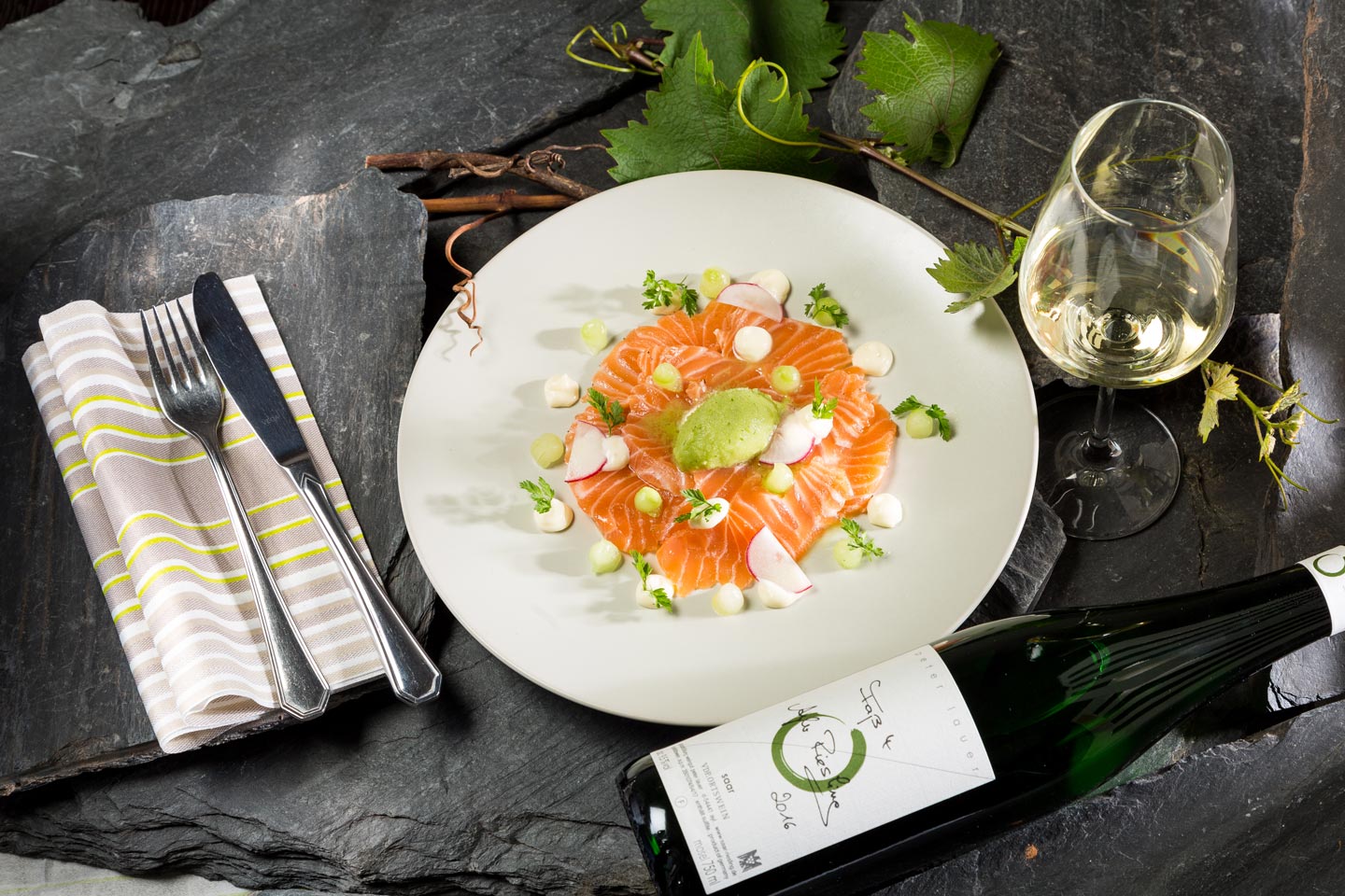 Plate of salmon next to a glass of wine
