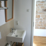 Hotel bathroom with toilet, sink, and mirror