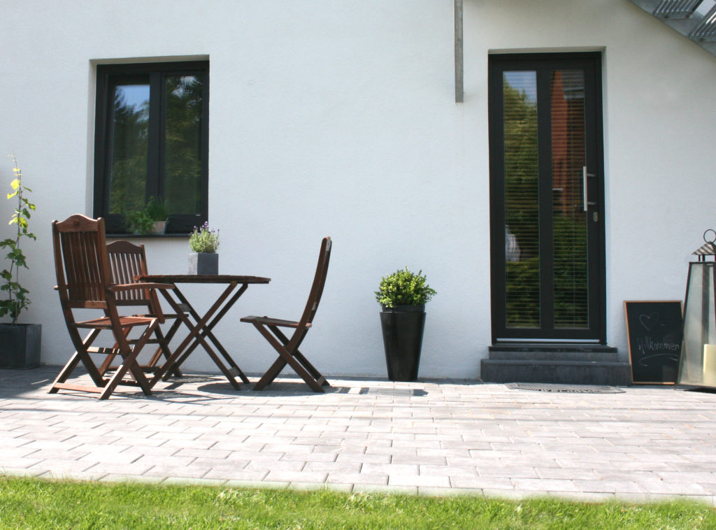 Terrace with plants in vases and building entrance