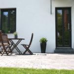 Terrace with plants in vases and building entrance