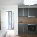 Kitchen with stove, cupboard, and table