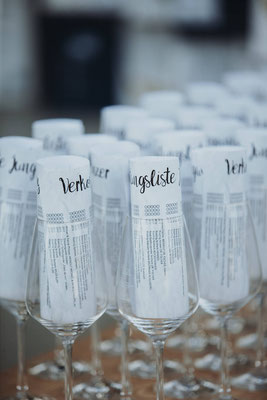 Rolled up paper notes in wine glasses